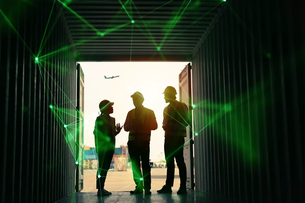 silhouette of transport workers in container with a plane and containers behind and a plane in the sky overlayed with green plexus