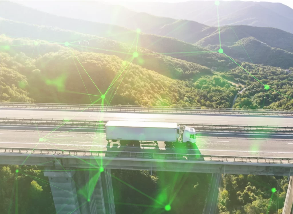 Lorry driving on road with picturesque landcscape in the background, glare from the sun on the camera lens and overlayed with a green plexus