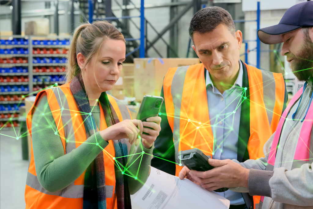 2 men and and a woman inside a warehouse looking at a mobile device for warehouse planning with overlayed green plexus