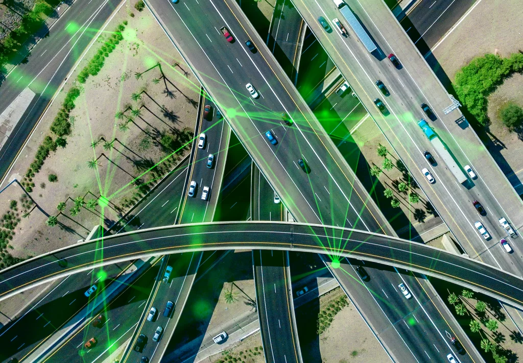 aerial-view-busy-highway-intersection-full-traffic-during-daytime-green-plexus-overlayed