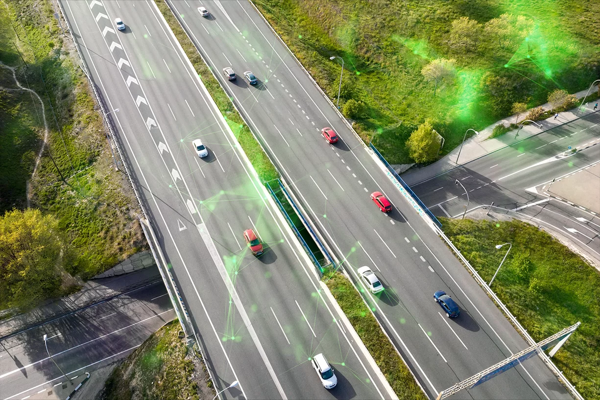 cars driving on a highway aerial shot with green plexus overlayed