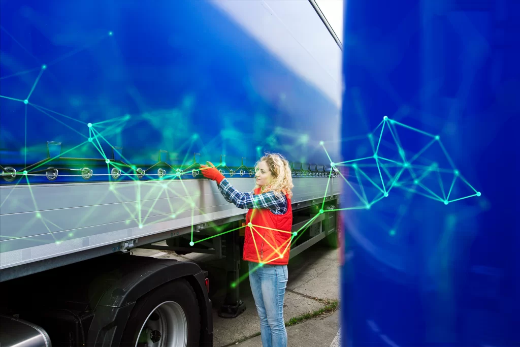 female truck driver looking at vehicle with green plexus overlayed