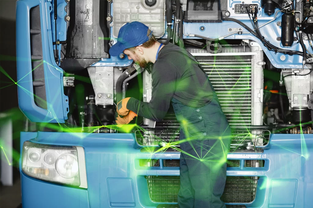 man with tools working on a lorry engine with green plexus overlayed