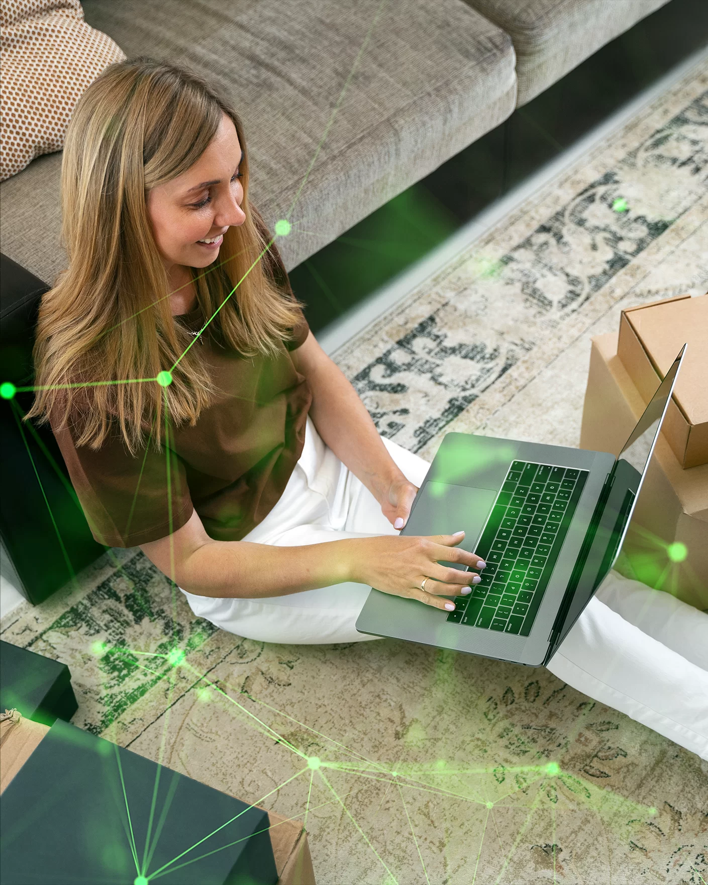 woman on computer with boxes tracking her delivery with green plexus overlayed