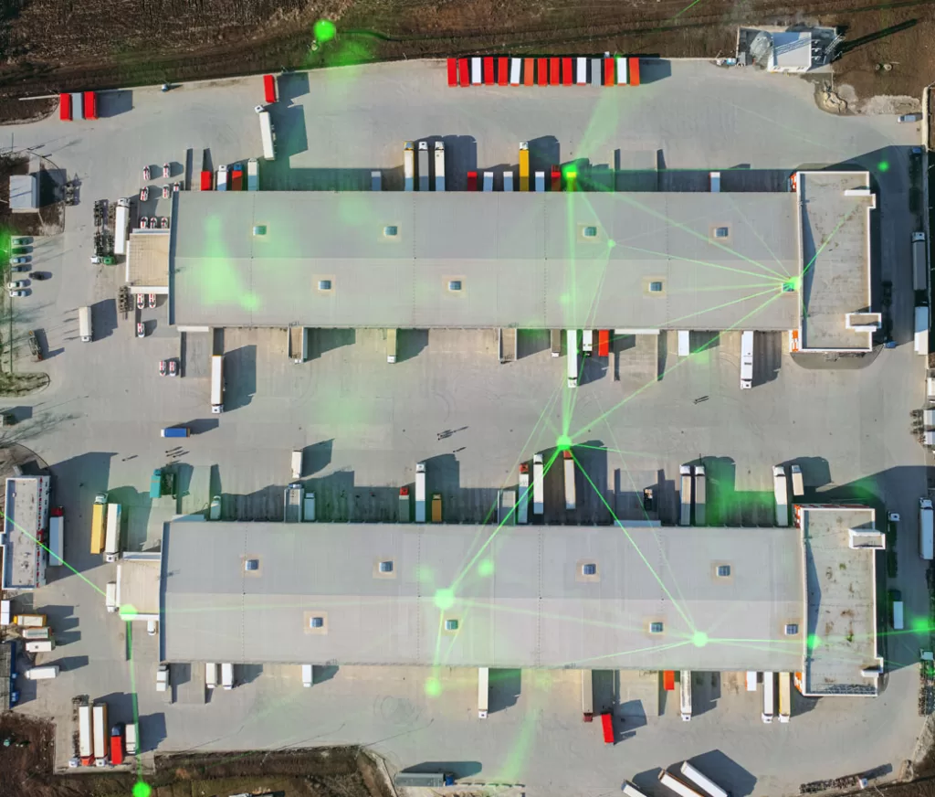 aerial view of warehouse with trucks waiting ot be loaded green plexus overlayed