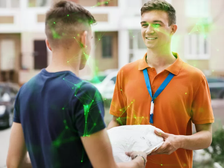 son wearing an orange T-shirt and a name tag is delivering a parcel to a client