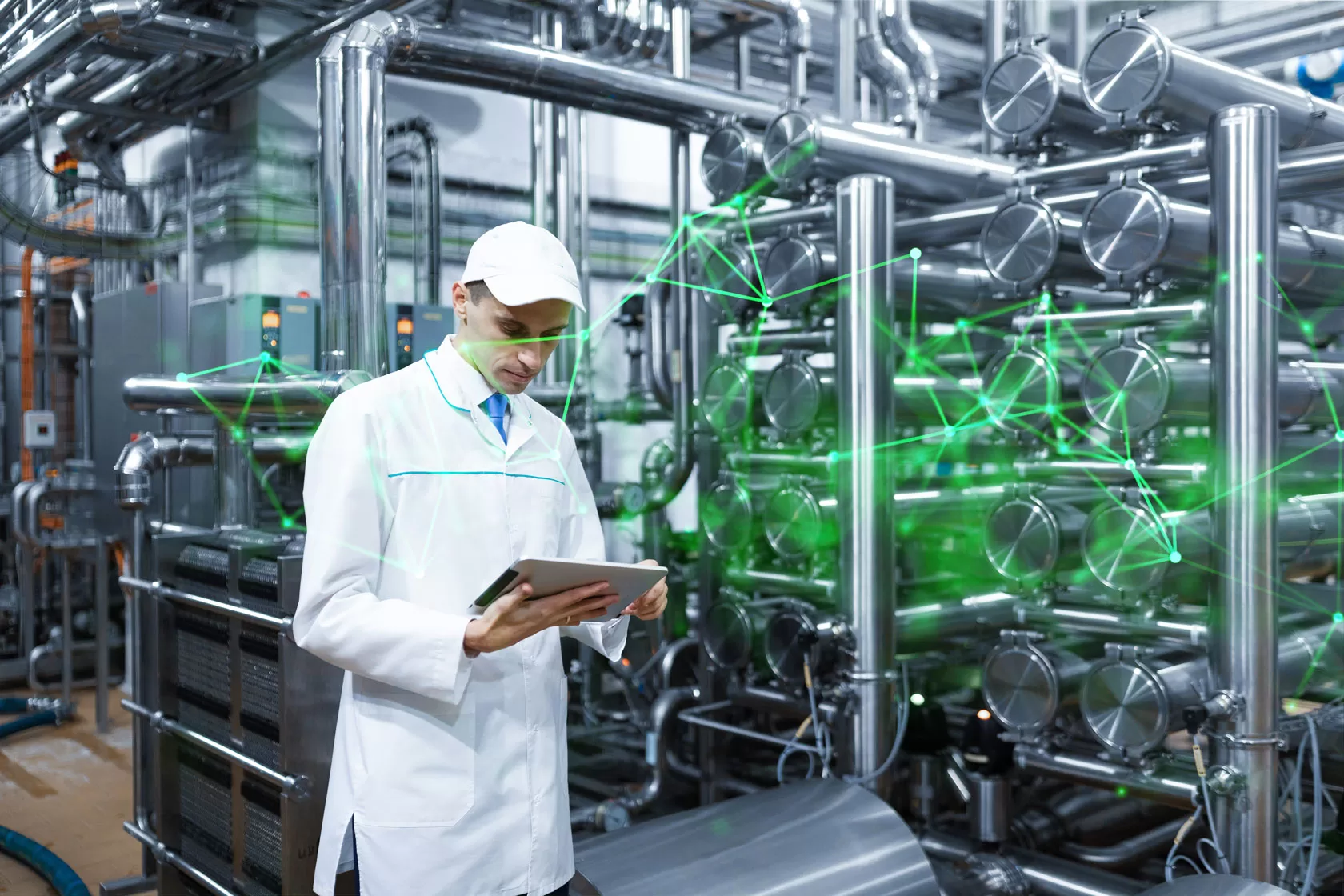 Man in lab white coat holding a tablet in a food factory with silver machinery and green plexus overlayed