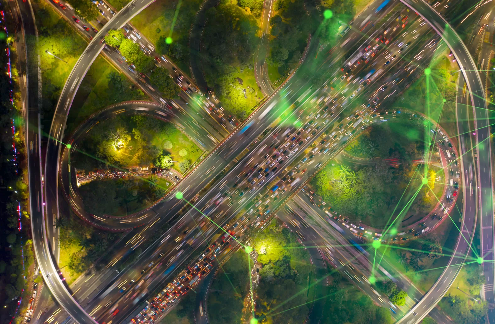 aerial view of circular road in dark with lights and green plexus overlayed