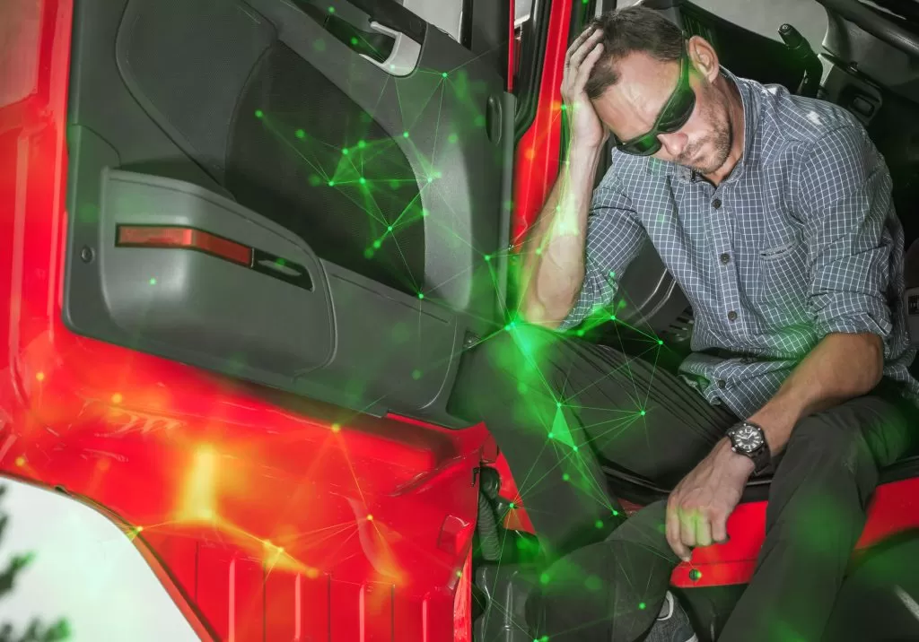 truck driver with sunglasses, tired sitting inside HGV with green plexus overlayed