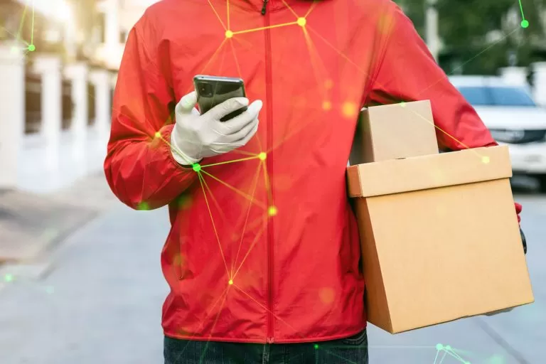 Cropped man in red coat holding phone and packages green plexus overlayed