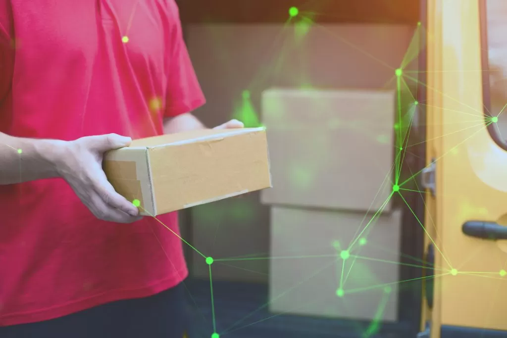 man holding tan cardboard box green plexus