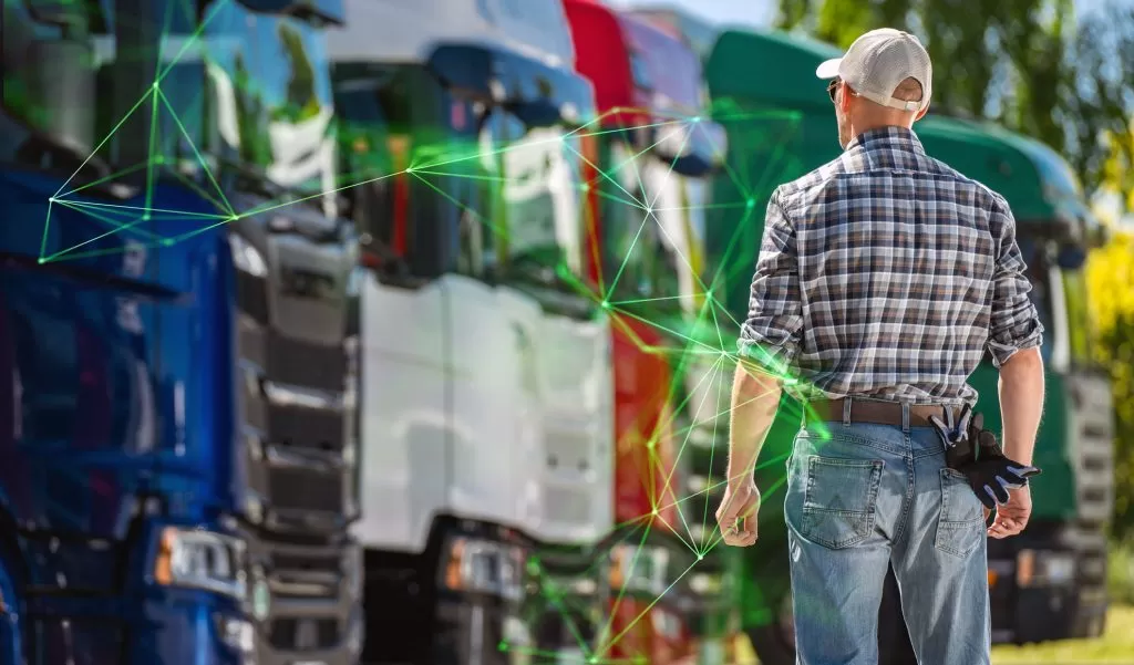 truck driver inspecting fleet colourful trucks transportation yard green plexus food logistics