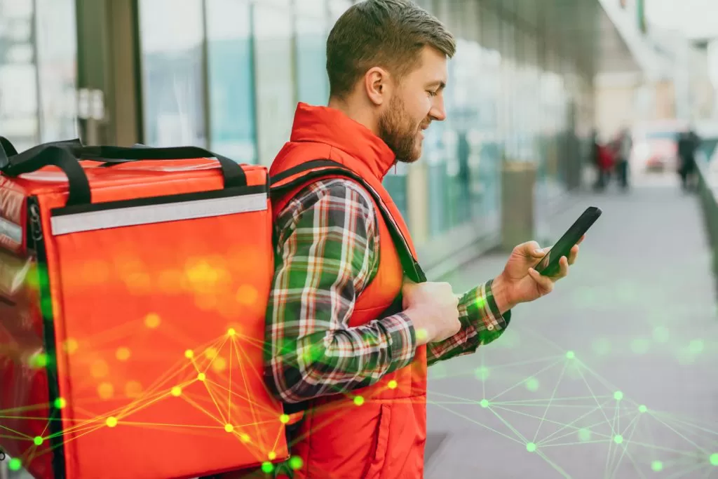 food delivery man with boxes with food using google maps green plexus