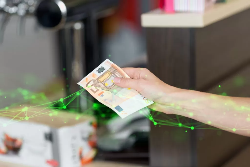 woman's hand handing cash with green plexus overlayed