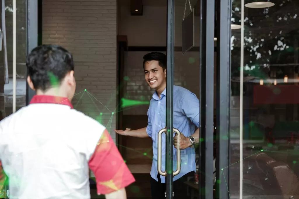 young-barber-expert-smiling-welcoming-customer-sales-representative-green-plexus