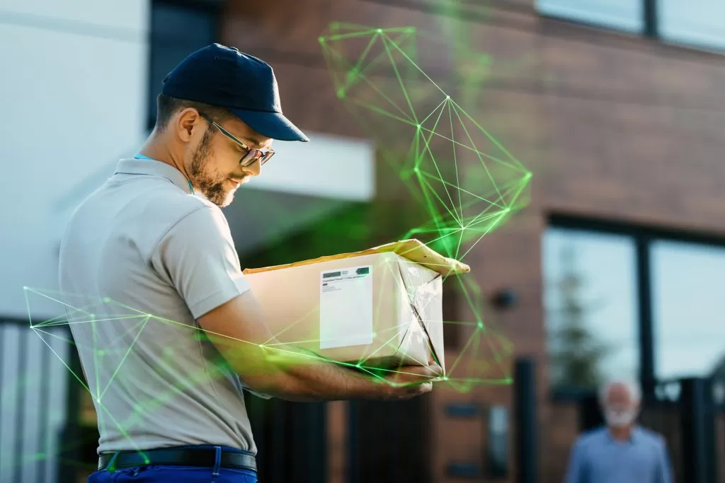 young delivery man carrying package reading address label his customer is standing background green plexus