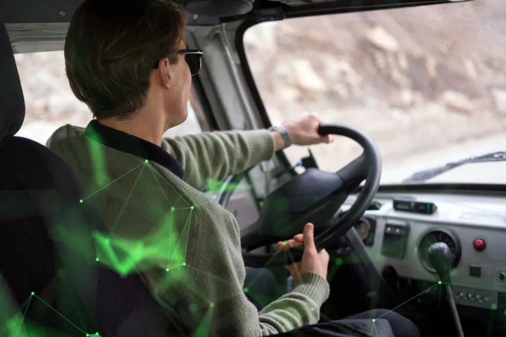 back view of man driving lorry on road with a green plexus overlay