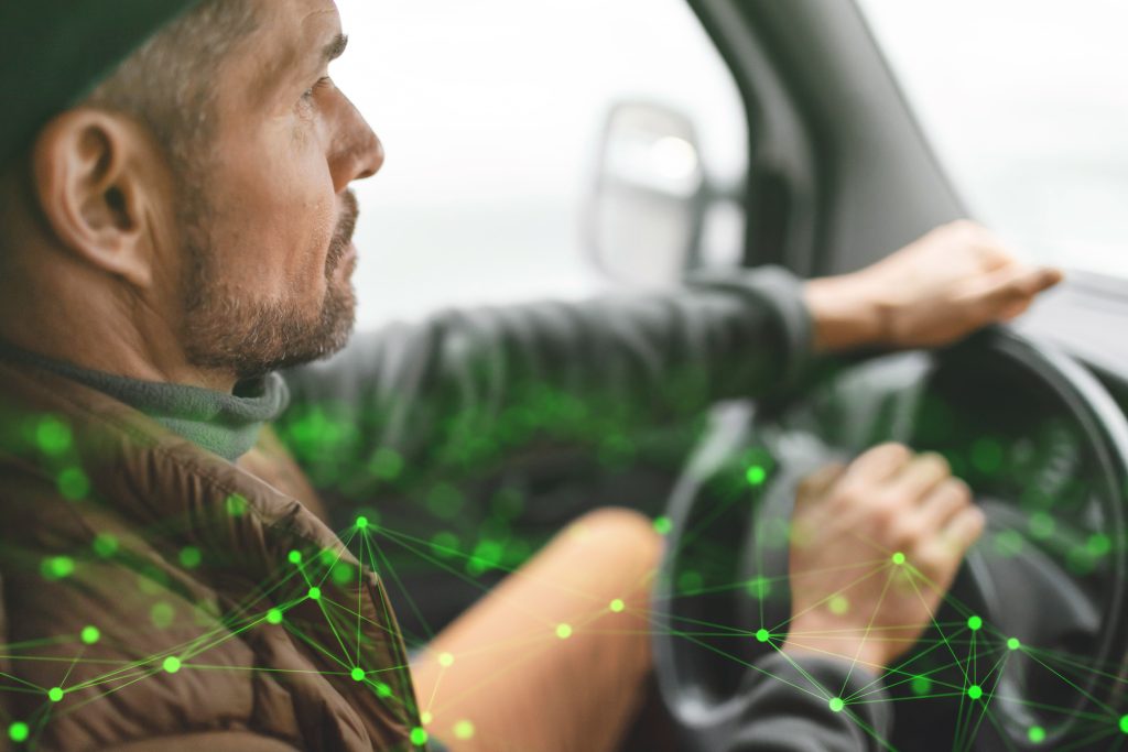 close up image of man driving a lorry with a green plexus overlay