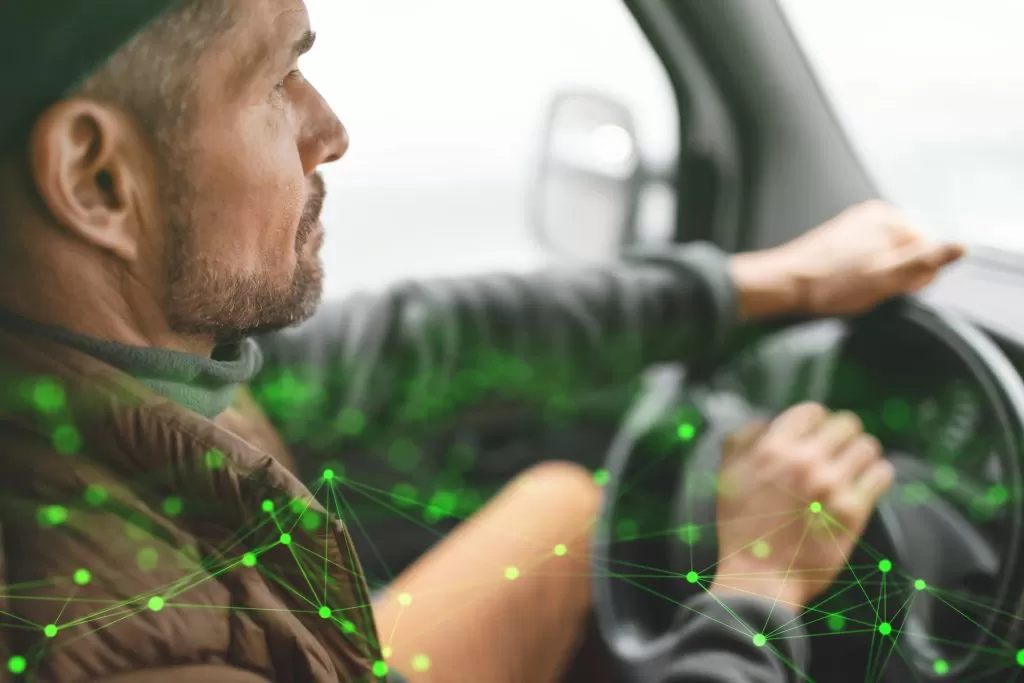 close up image of man driving a lorry with a green plexus overlay