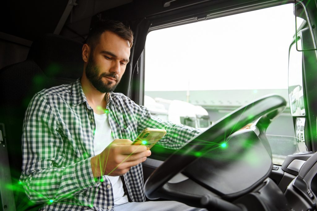 man using transportation app in lorry whilst driving with a green plexus overlay